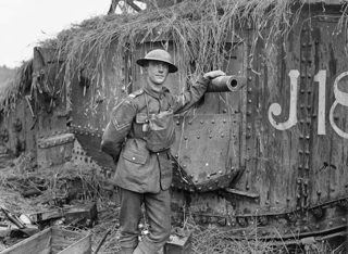 A British Corporal Stands Beside His Camouflaged